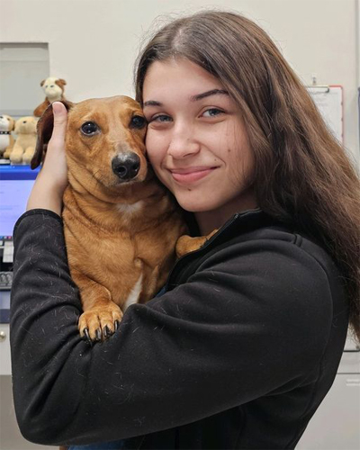 Emily holding a dachshund